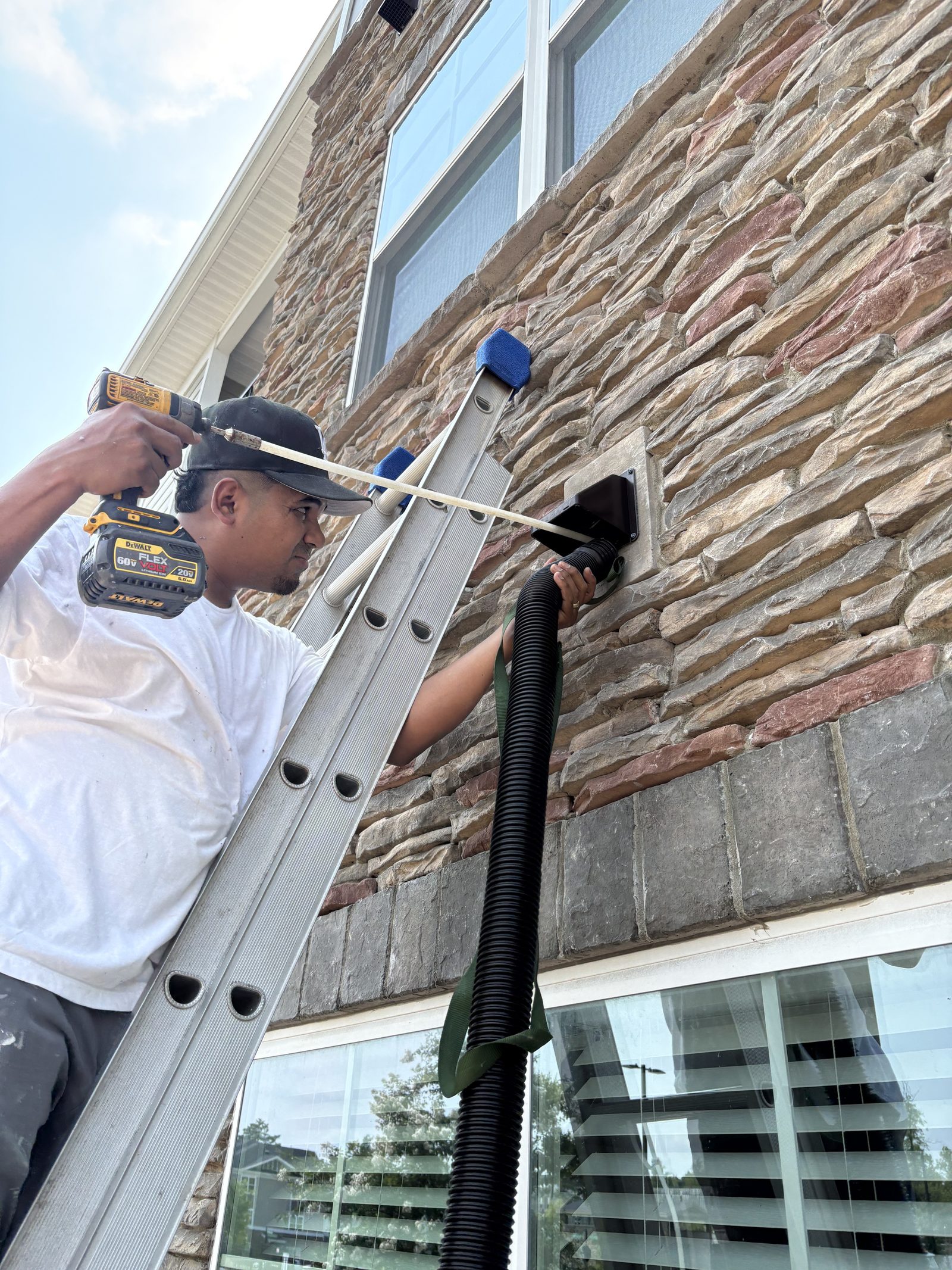 Technician cleaning a multifamily dryer vent